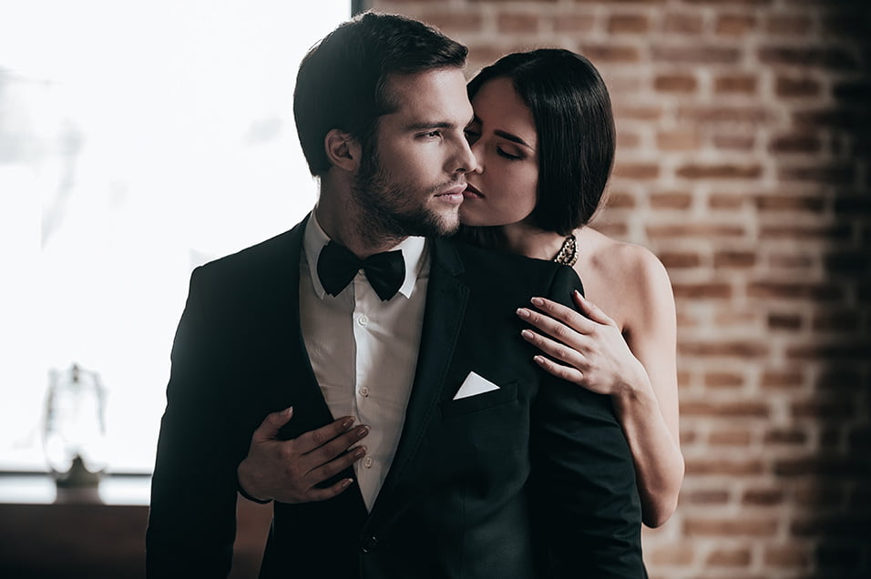 A man and woman wearing tailored Peter Parvez custom-fit garments