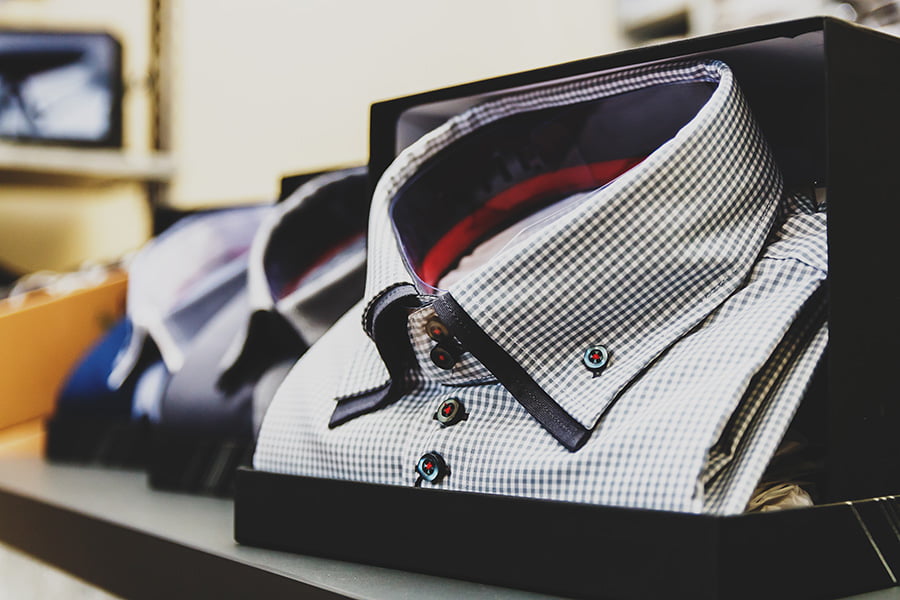 A stack of finished Peter Parvez custom dress shirts on display